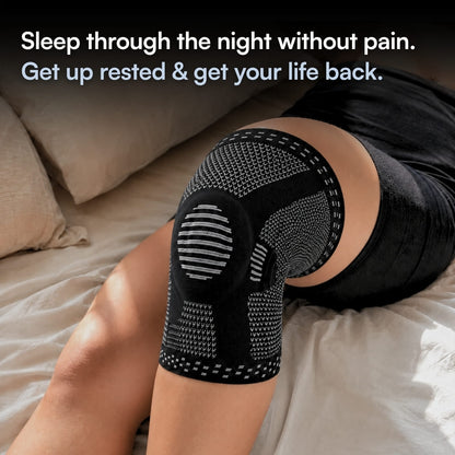 A person lying on a bed wearing a black knee compression sleeve with gray knit panels and text at the top that reads, 'Sleep through the night without pain. Get up rested & get your life back.